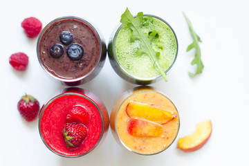  Smoothie juice with healthy fresh raw  fruits and vegetables on white planks
