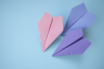 Three paper planes on blue background.