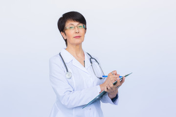 Portrait Of Female Doctor Writing On Clipboard Over a white background