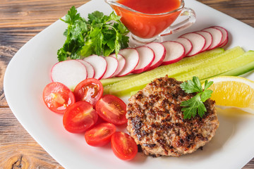 Chopped steak cutlet cooked on grill on white plate