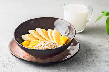 Oats Barley Wheat Rye Corn mix flake proper nutrition diet with pieces banana orange and glass of...