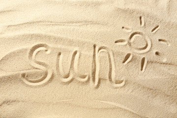 Fototapeta na wymiar Word SUN written on beach sand