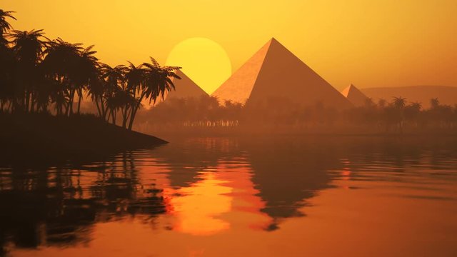 Lake with palms, sand, and silhouettes of the ancient pyramids on the horizon.