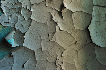 a surface with an old cracked paint splitting large pieces
