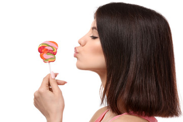 Young woman with lollipop on white background