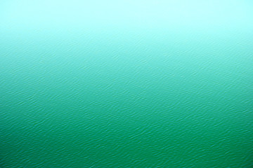 Fototapeta na wymiar Beautiful texture with turquoise water with fog above, Background