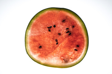 a watermelon cut on a white surface