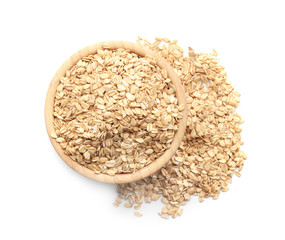 Bowl with raw oatmeal on white background