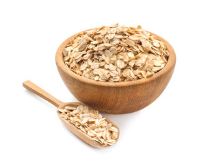 Bowl and scoop with raw oatmeal on white background