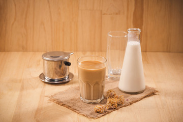 Milk bottle and milk glass on wooden table. Healthy eating concept