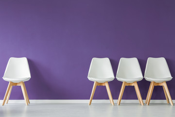 Chairs on purple wall