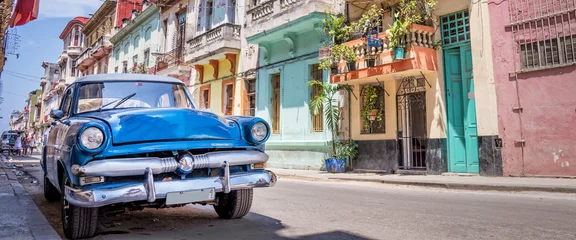 Printed kitchen splashbacks Vintage cars Vintage classic american blue car in a colorful street of Havana, Cuba web banner. Panoramic cuban travel and tourism photo