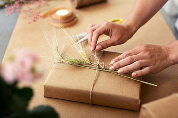 Wonderful present. Close up of a gift being wrapped in a beautiful gift box