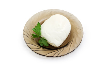 Mozzarella cheese with parsley on dark glass saucer