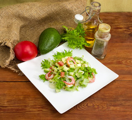 Avocado salad with vegetables and some ingredients for its preparation