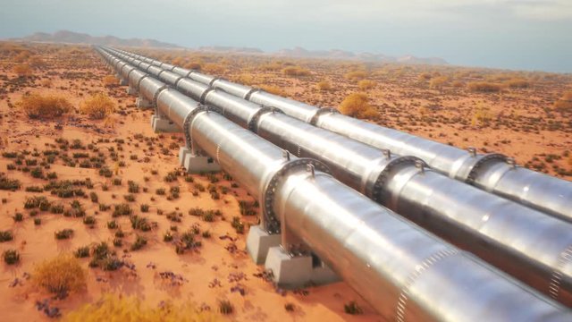 Parallel metal pipelines crossing a desert in a forward tracking shot