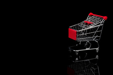 Empty shopping cart on black background