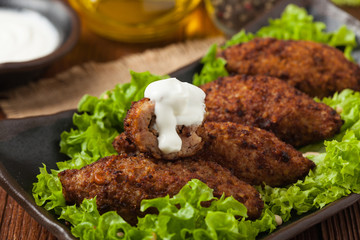 Traditional arabic kibbeh with lamb and pine nuts.