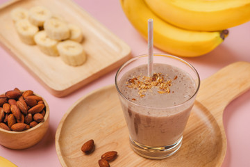 Fresh made Banana smoothie on pink background