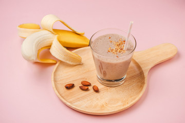 Fresh made Banana smoothie on pink background
