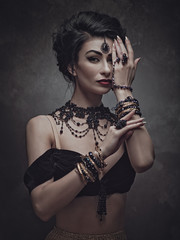 Secret face. Mata Hari. Belly Dancer. Ethno styled female portrait with oriental bijou