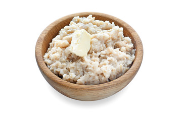 Tasty oatmeal in bowl on white background