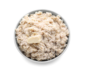 Tasty oatmeal in bowl on white background