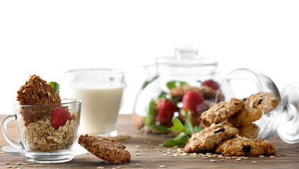 Delicious oatmeal cookies with flakes on table