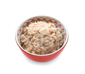 Bowl with tasty oatmeal on white background