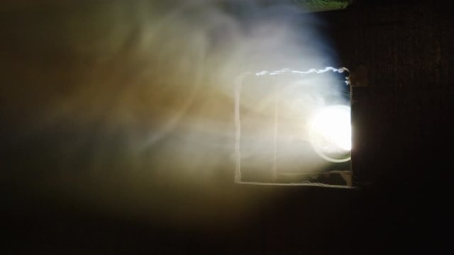 smoke cloud hides cinema projector in darkness