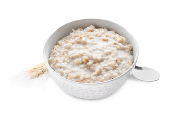 Bowl with tasty oatmeal and spoon on white background