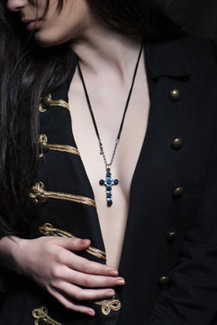 Closeup Shot Of A Brunette Woman With A Christian Symbolic Necklace On Her Neck.