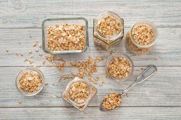 Composition with raw oatmeal on wooden background
