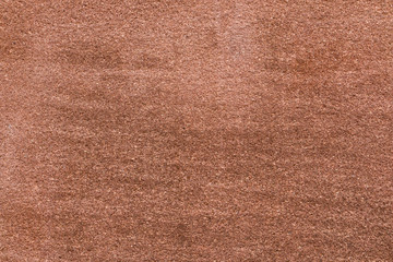 Brown sandstone wall texture details. Close-up photo of gritty background. Horizontal orientation