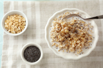 Composition with tasty oatmeal on table