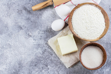 Baking ingredients for cake, pie, shortbread pastry: flour, eggs, sugar, butter, rolling pin and on...