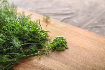 Fototapeta premium Board with fresh dill on table, closeup
