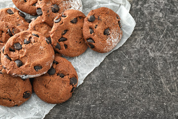 Delicious cookies with chocolate chips on table