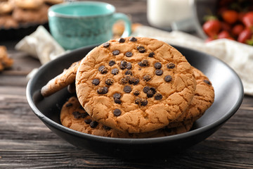 Delicious cookies with chocolate chips in bowl
