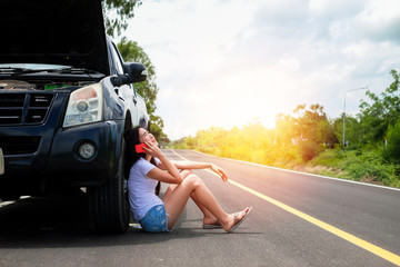 Asia woman have a problem about her car.beautiful lady calling to insurance to help and fix her broken car stop near the road during her travel on vacation.