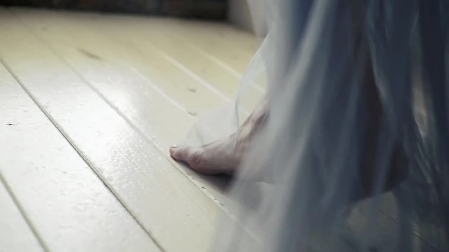 Beautiful young girl bare feet moving on interior in the living room in slow motion.