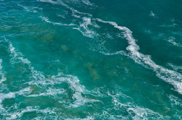 Fototapeta na wymiar Ocean water. Texture of turquoise ocean water. Background shot of aqua sea water surface