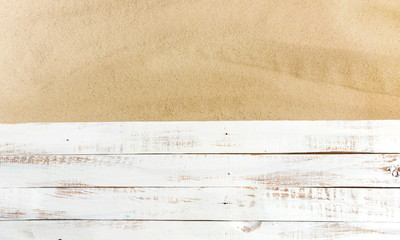 Sand on a white planked wood. Summer background. Flat lay, top view, copy space  - obrazy, fototapety, plakaty
