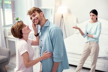 Pleasurable mood. Happy joyful woman looking at her son while enjoying her time with him