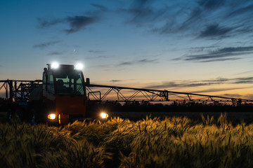 Machine for spraying pesticides and herbicides in the field at night. 