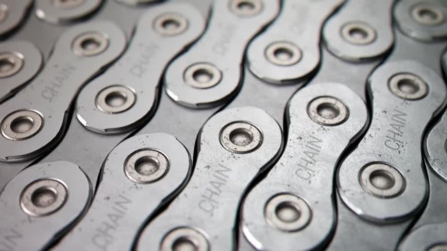 Close-up of metal chain links arranged in parallel rows