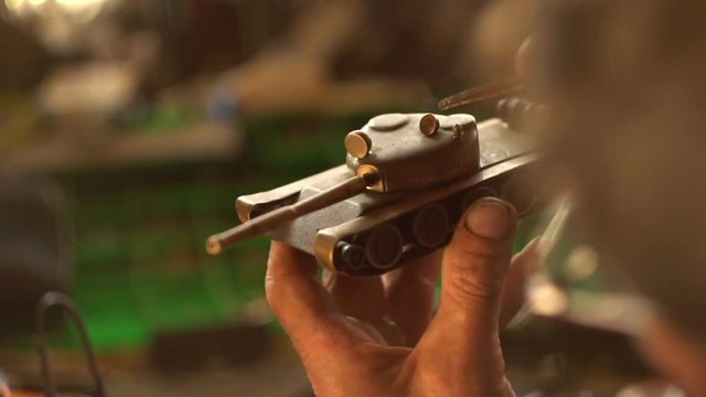 old vinatge model tank in hand man