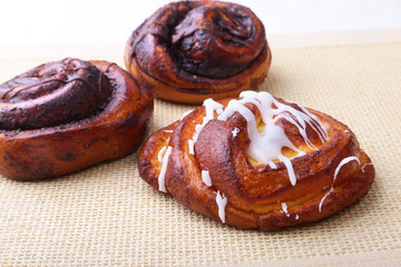 Freshly baked homemade sweet rolls with cinnamon on white background. Healthy Food Snack Concept. Copy space.
