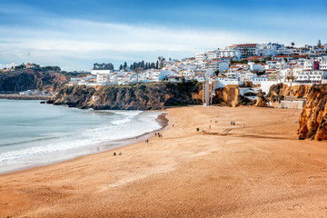 Beach Albufeira, Portugal, the beautiful coast of the Atlantic Ocean, sandy beach, a popular destination for travel and holidays in Europe © olezzo