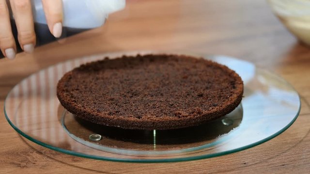 Cake-making: the cake is soaked with sweet syrup for moisture.
